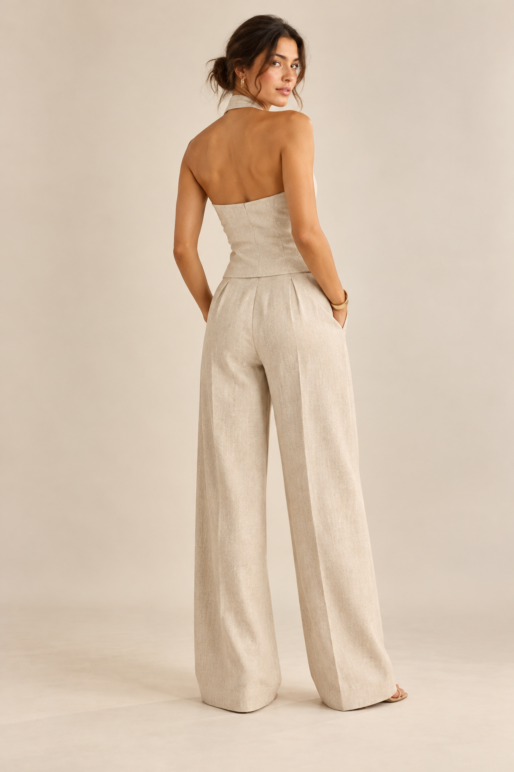 Back view of beige halter waistcoat and matching wide-leg trousers