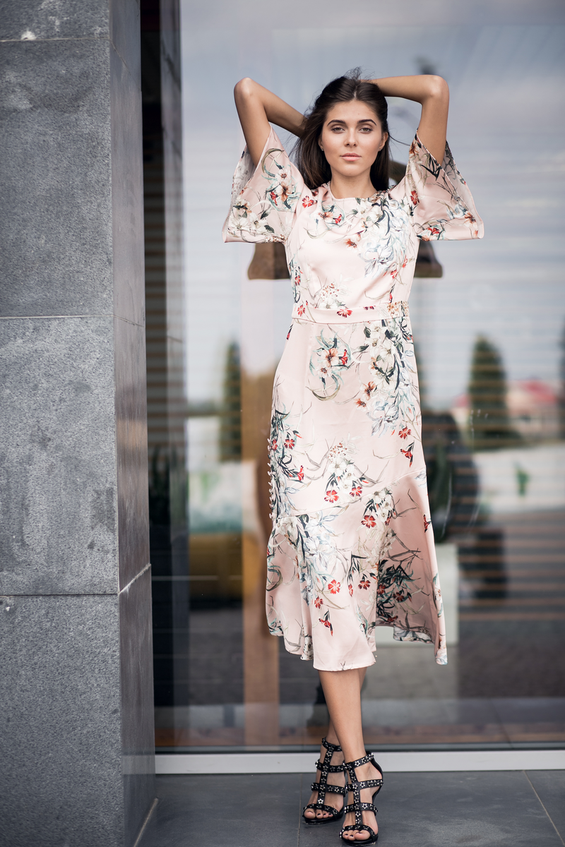 Front view of a blush pink floral midi dress with short sleeves